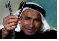 Palestinian man shows keys to house taken by Israelis.